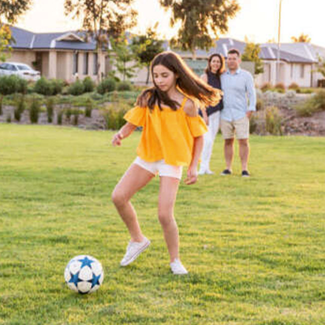 Almond grove estate teen playing soccer in the park